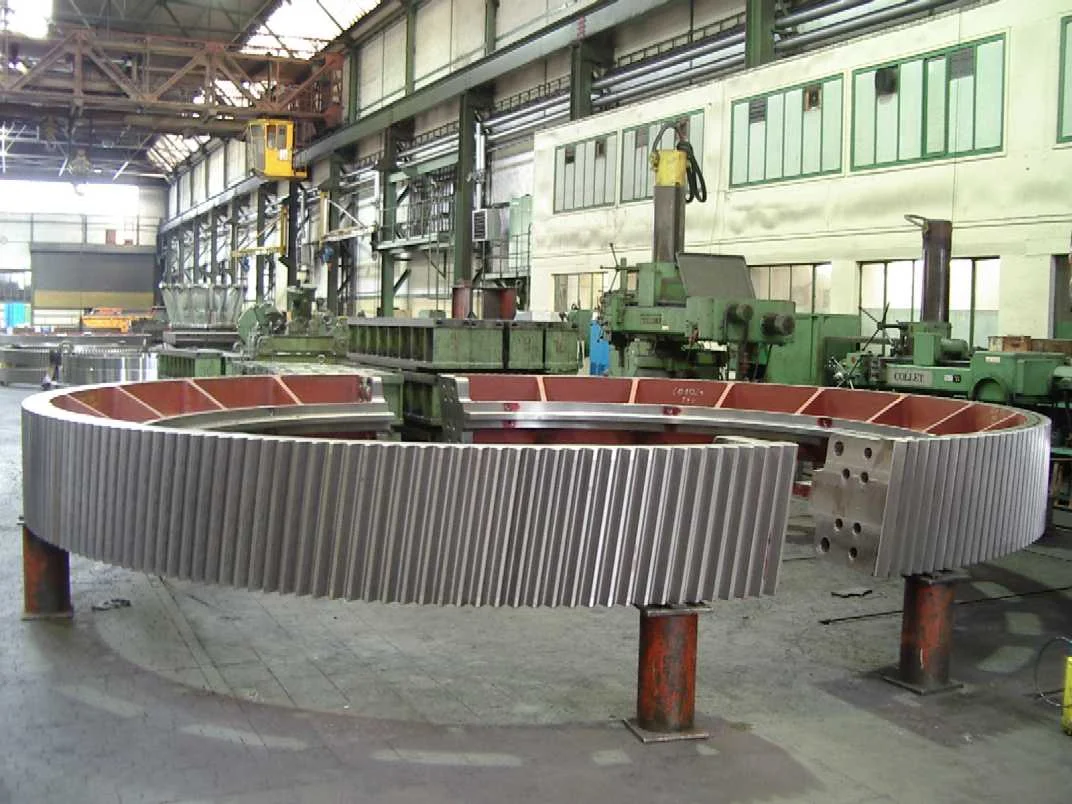 Assembled two-segment girth gear standing on supports in a machine shop